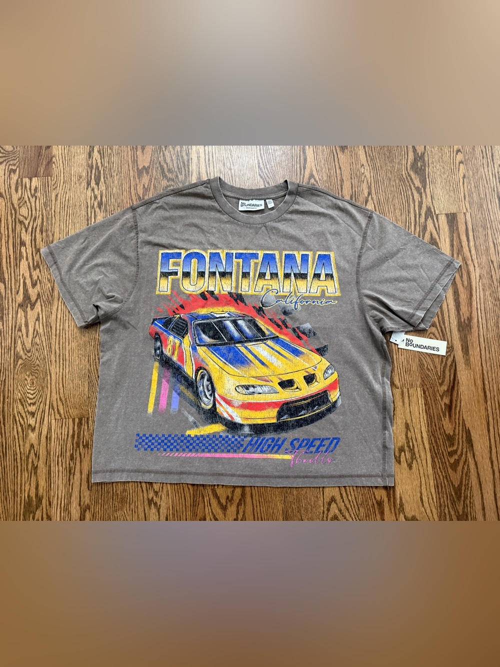 No Boundaries acid taupe boxy tee with inspired Yellow & Blue Racecar graphic.